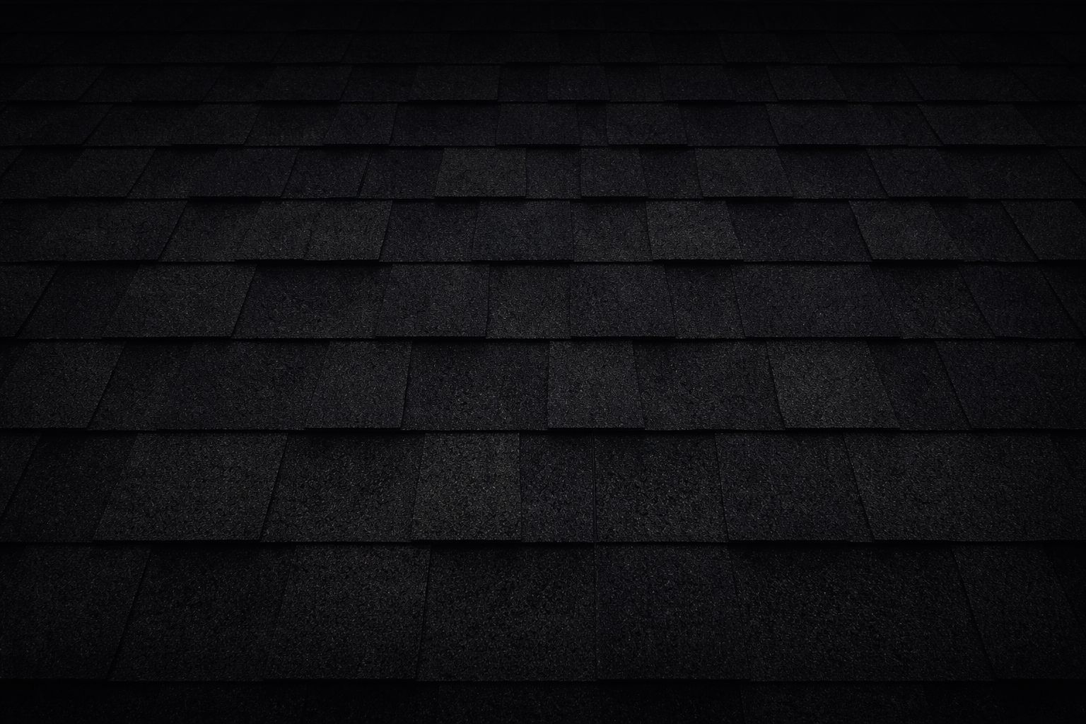 Dark shingled roof in low light