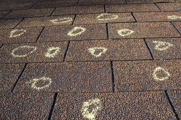 Chalk-drawn circles and dots on a brick pavement game grid